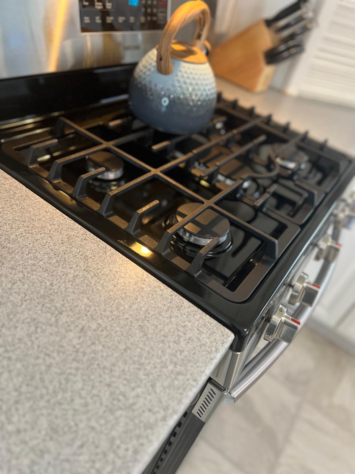 Polished stainless steel kitchen sink and clean countertop